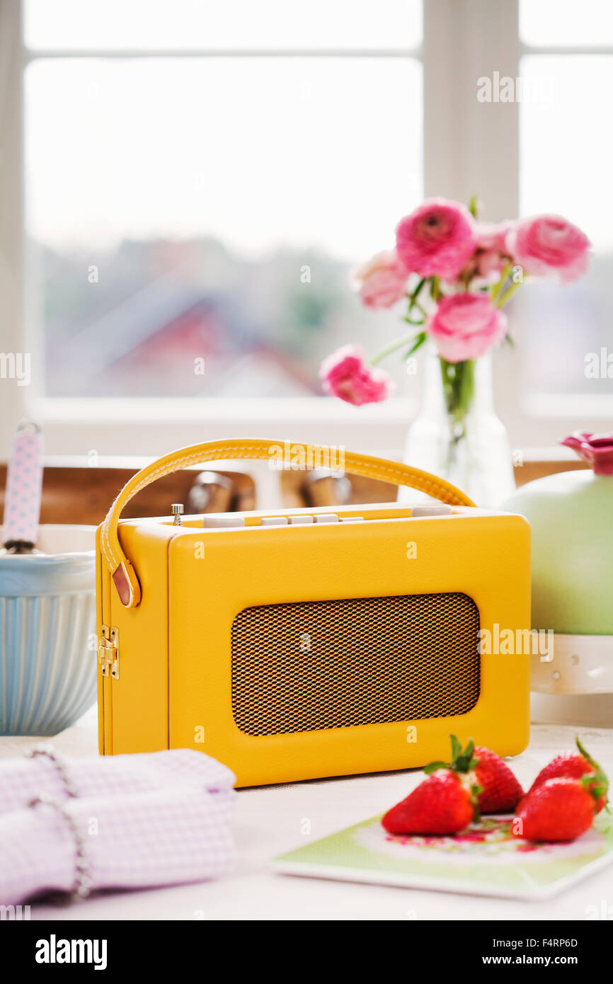Old fashioned radio and strawberries on table Stock Photo