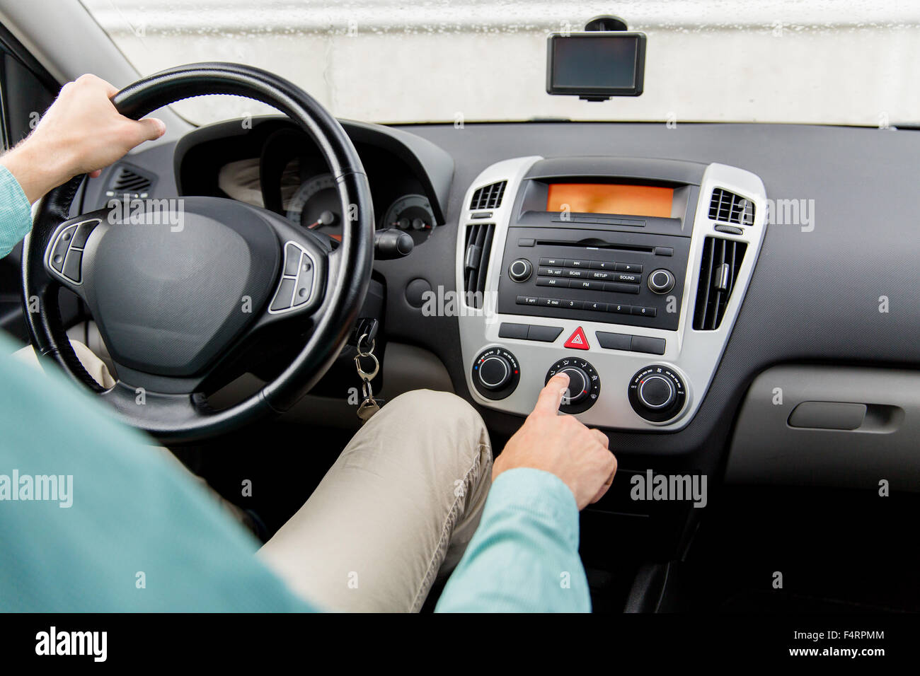 close up of male hand using climate control in car Stock Photo