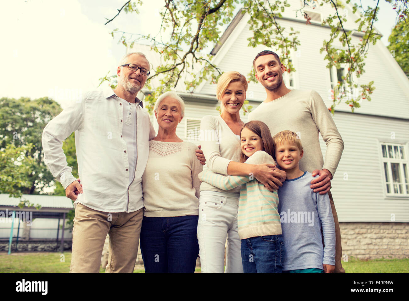 happy family in front of house outdoors Stock Photo - Alamy
