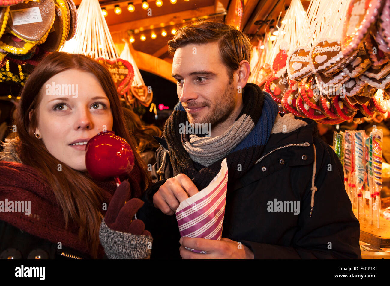 couple with sweets on christmas market Stock Photo
