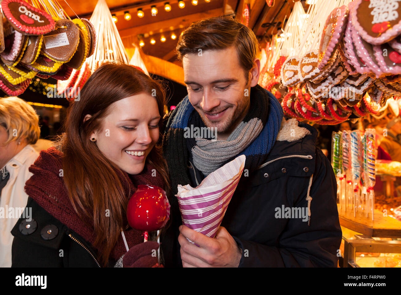 couple with sweets on christmas market Stock Photo