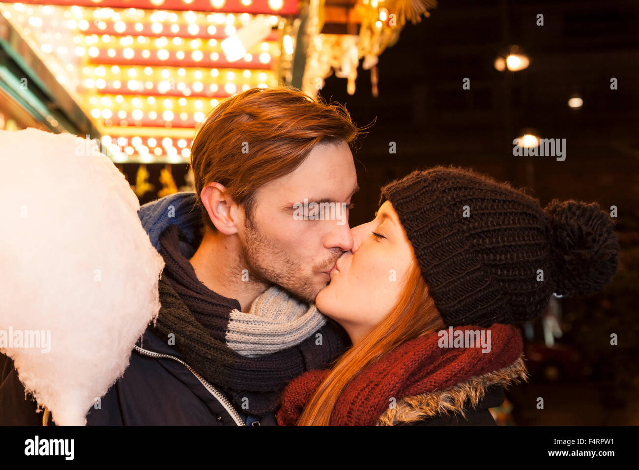 couple kissing on parish fair in winter Stock Photo