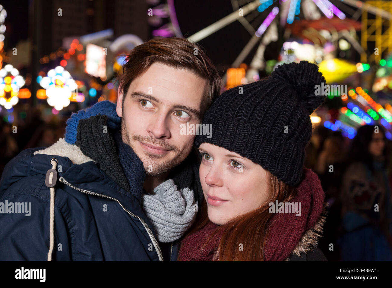 couple peer on parish fair in winter Stock Photo