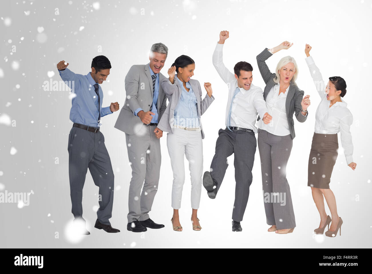 Composite image of business people cheering in office Stock Photo