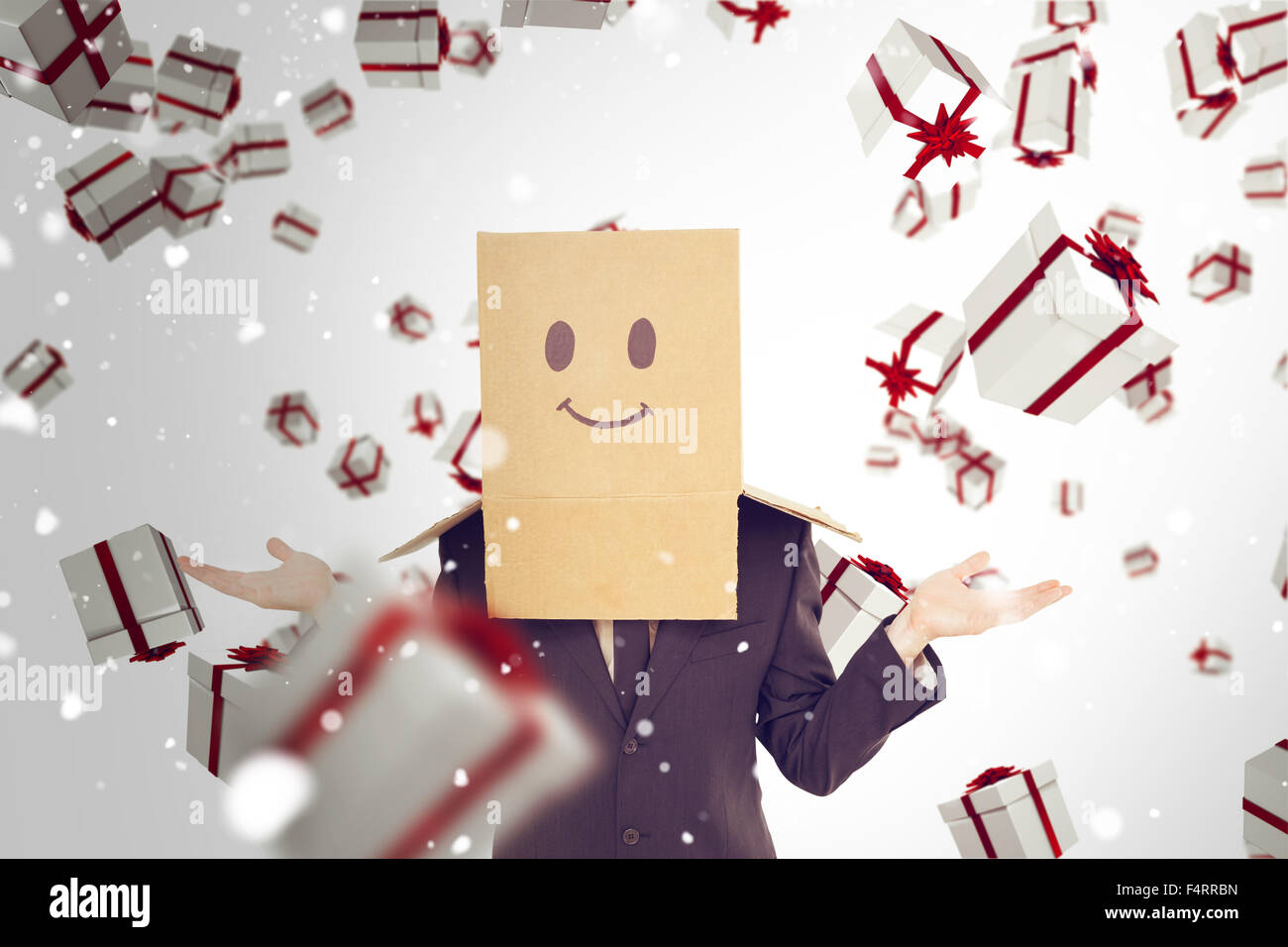 Composite image of businessman shrugging with box on head Stock Photo