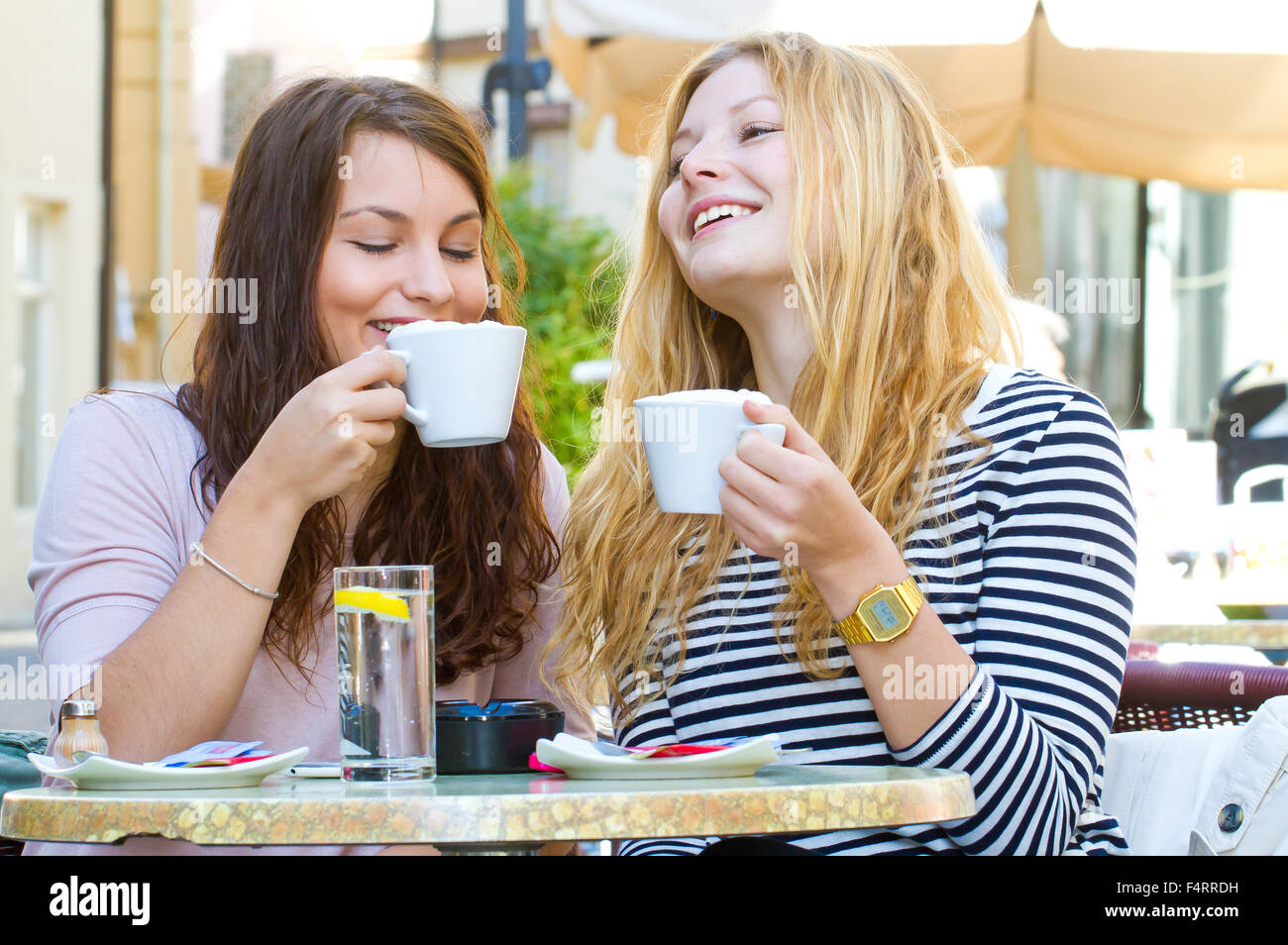 Two happy girls drinking coffee Stock Photo Alamy