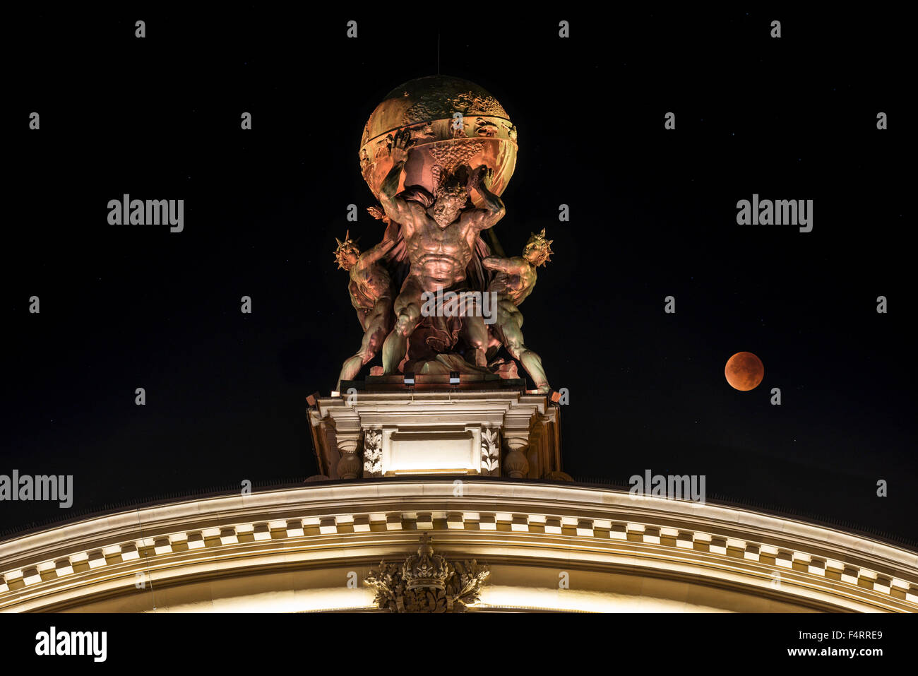 Sculpture of Atlas carrying globe, central station gateway, total lunar eclipse, Frankfurt am Main, Hesse, Germany Stock Photo