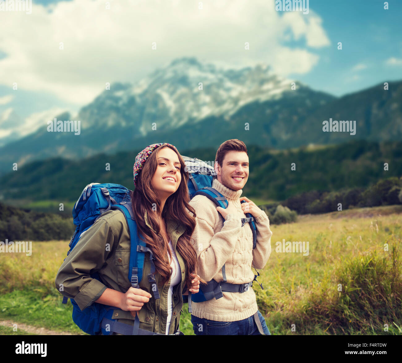 Smiling man woman hiking mountains hi-res stock photography and images ...