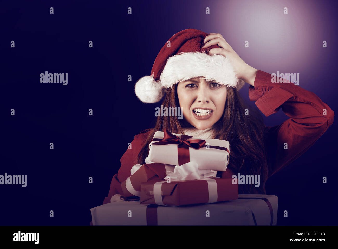 Festive stressed redhead holding gifts Stock Photo
