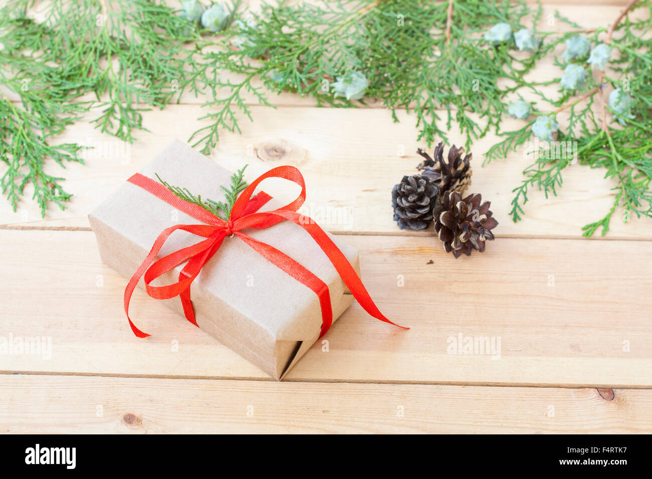 Christmas Gift, nuts, cones and green arborvitae branch on a wooden table Stock Photo