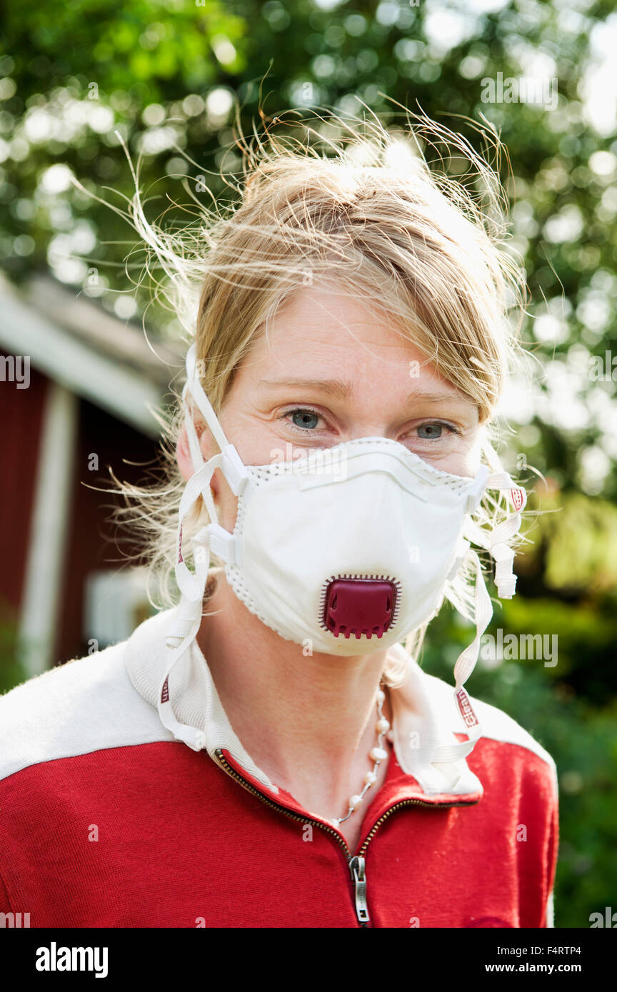 Sweden, Halland, Steninge, Portrait of farmer wearing protective mask Stock Photo