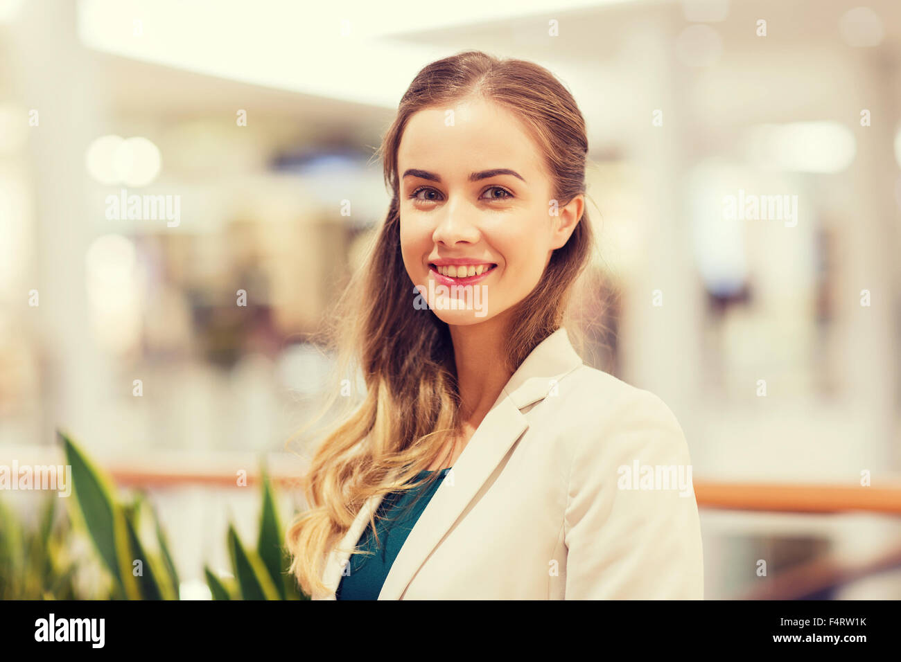 happy young woman in mall or business center Stock Photo