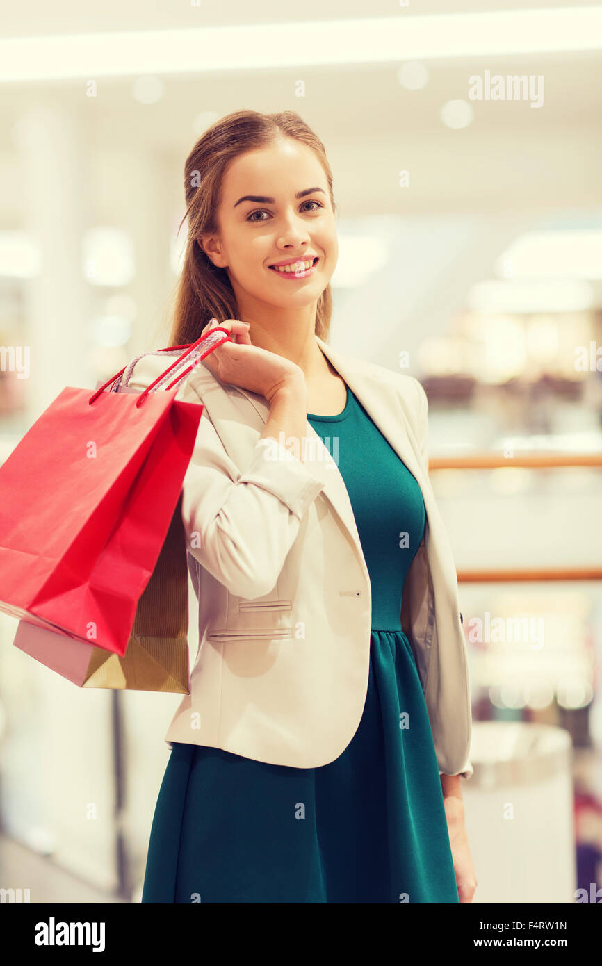 happy young woman with shopping bags in mall Stock Photo - Alamy