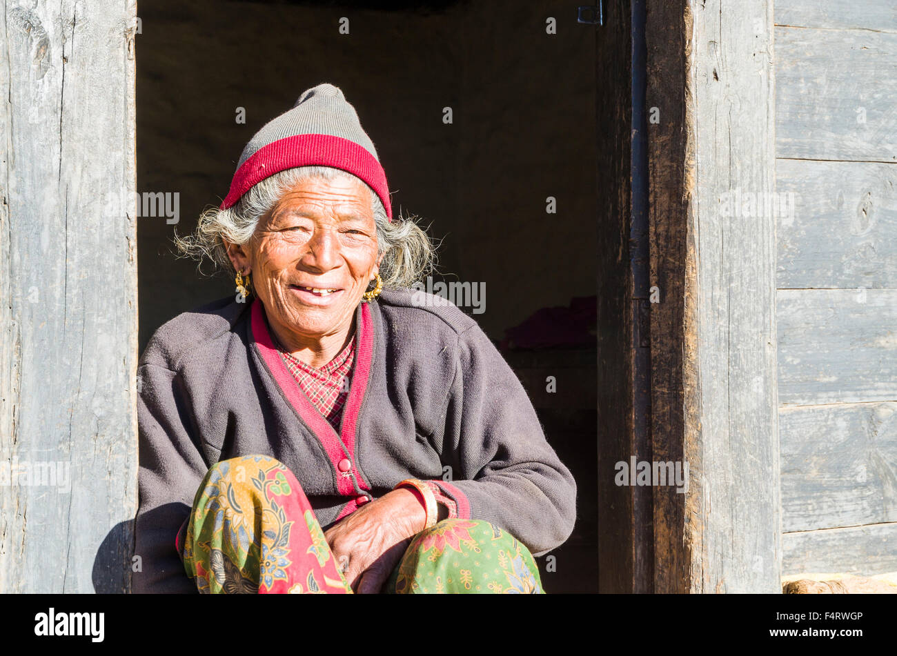 Old woman sitting in the doorway of a farmers house Stock Photo - Alamy