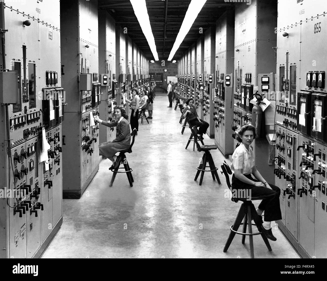 Calutron operators at their panels, in the Y-12 plant at Oak Ridge during World War II. 1944. The calutrons were used to refine Stock Photo