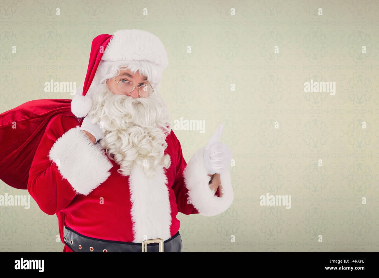 Composite image of santa claus with his sack and thumbs up Stock Photo ...