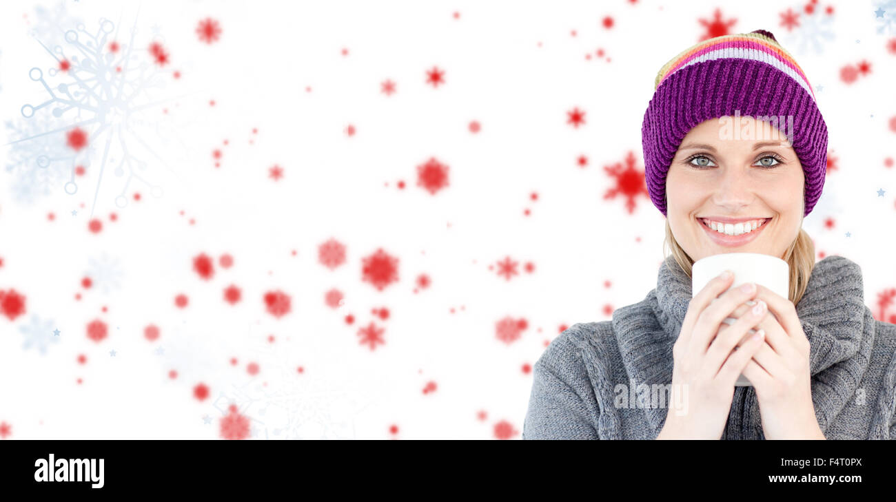 Composite image of smiling woman in a grey pullover against white background Stock Photo
