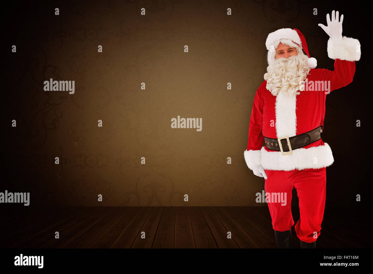 Composite image of cheerful santa claus waving Stock Photo - Alamy
