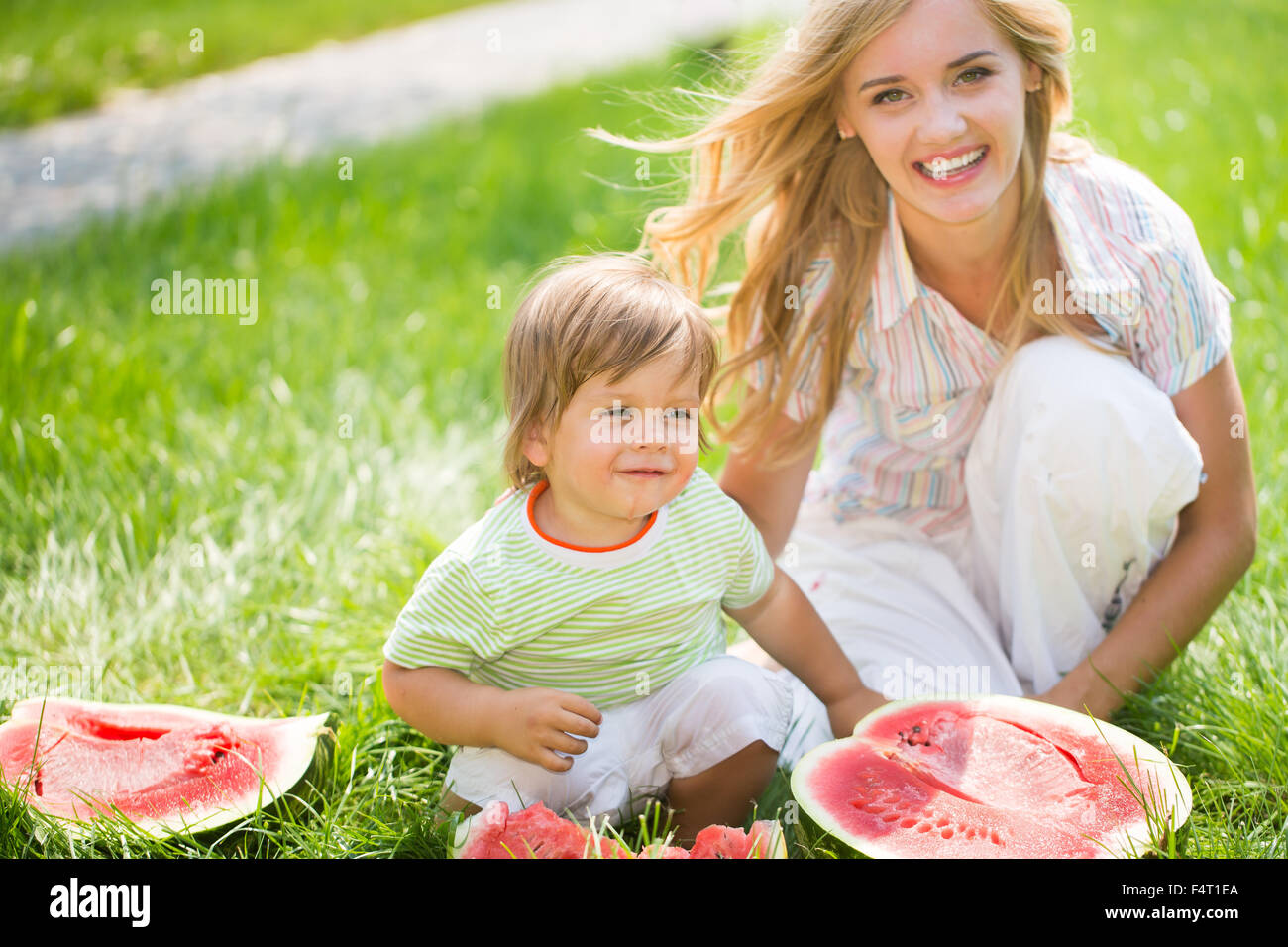 Blondie with her son on the grass Stock Photo