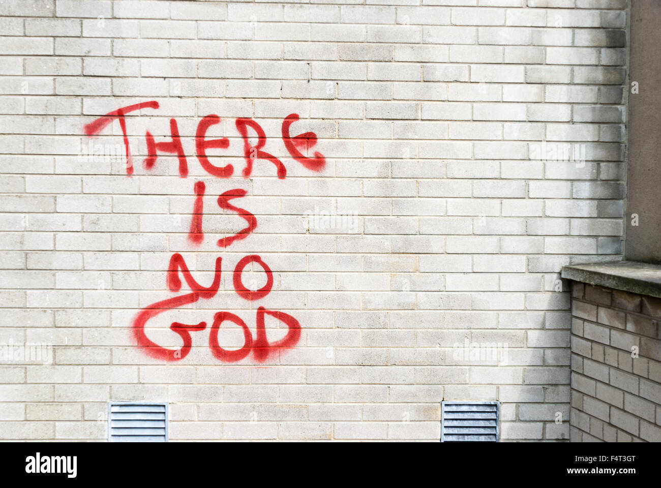 'There is no God' graffiti on the wall of a church. Stock Photo