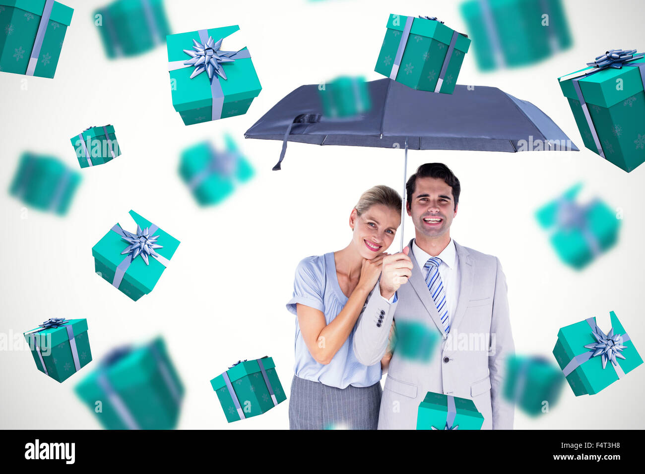 Composite image of business people holding a black umbrella Stock Photo