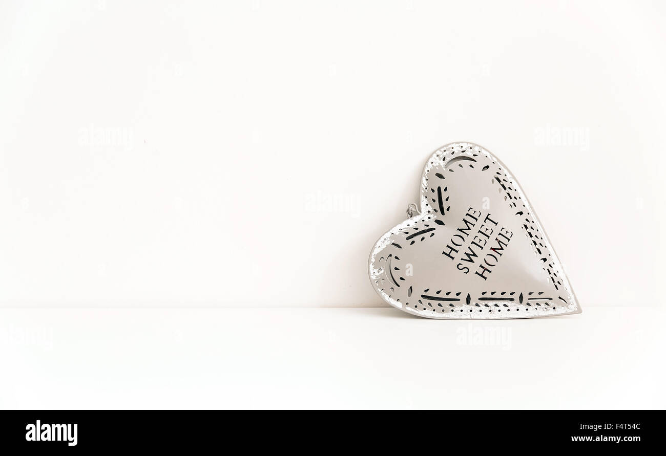 tin heart against white wall Stock Photo Alamy
