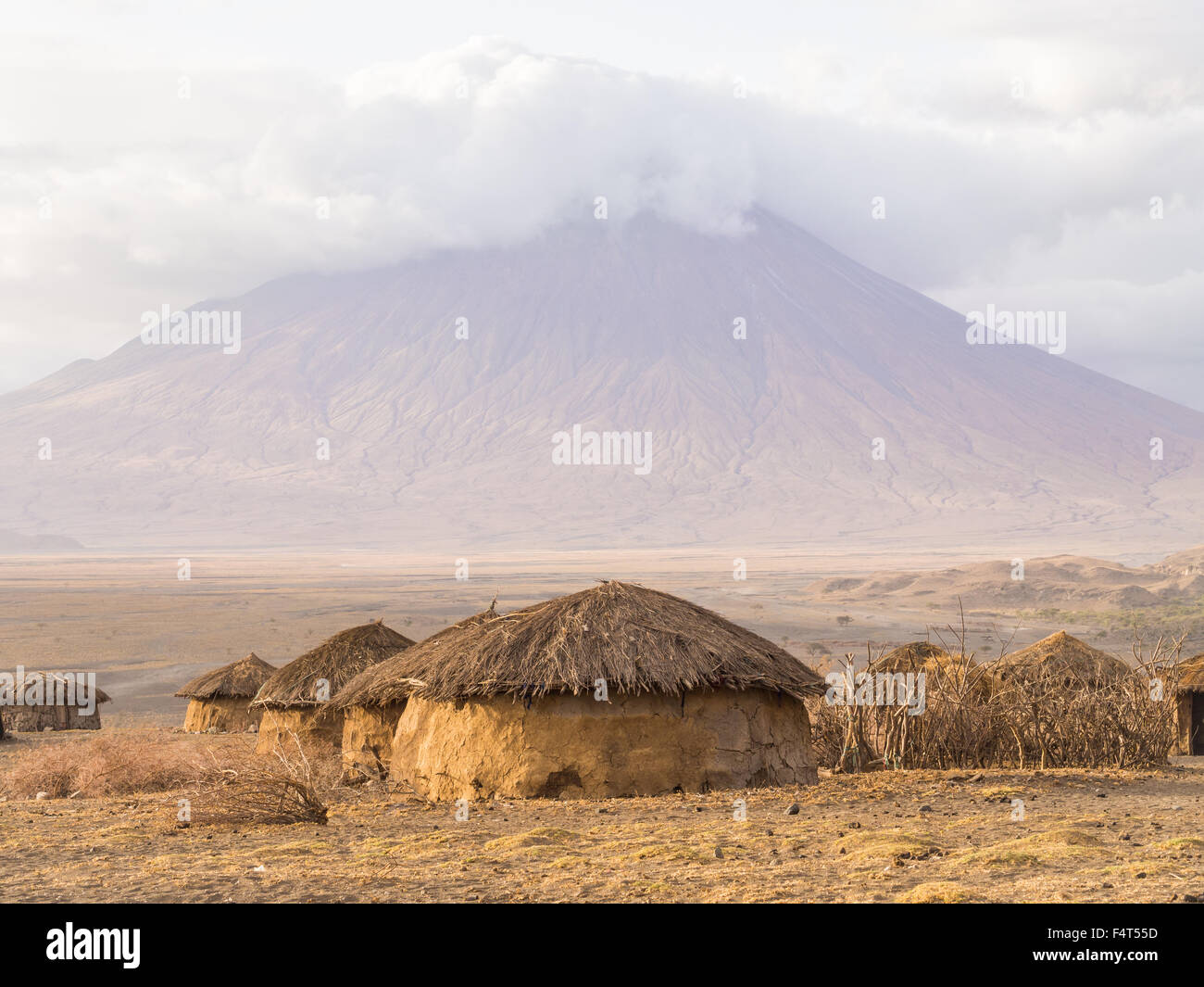 Maasai village in front of the Ol Doinyo Lengai (Mountain of God in the Maasai language) in Tanzania, Africa. Stock Photo