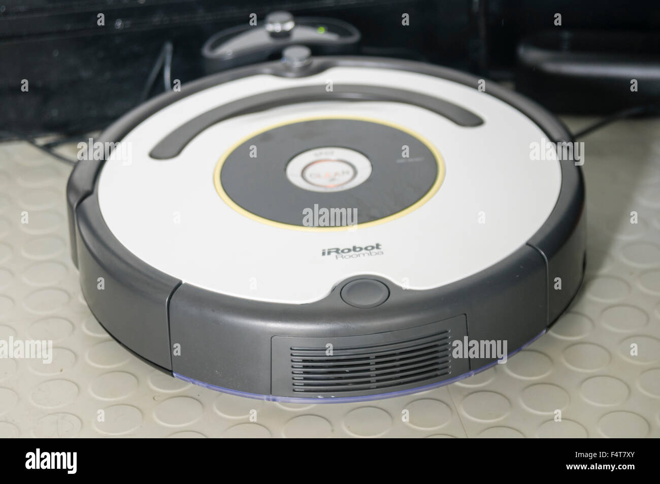 An iRobot Roomba robotic vacuum cleaner in its docking station Stock Photo