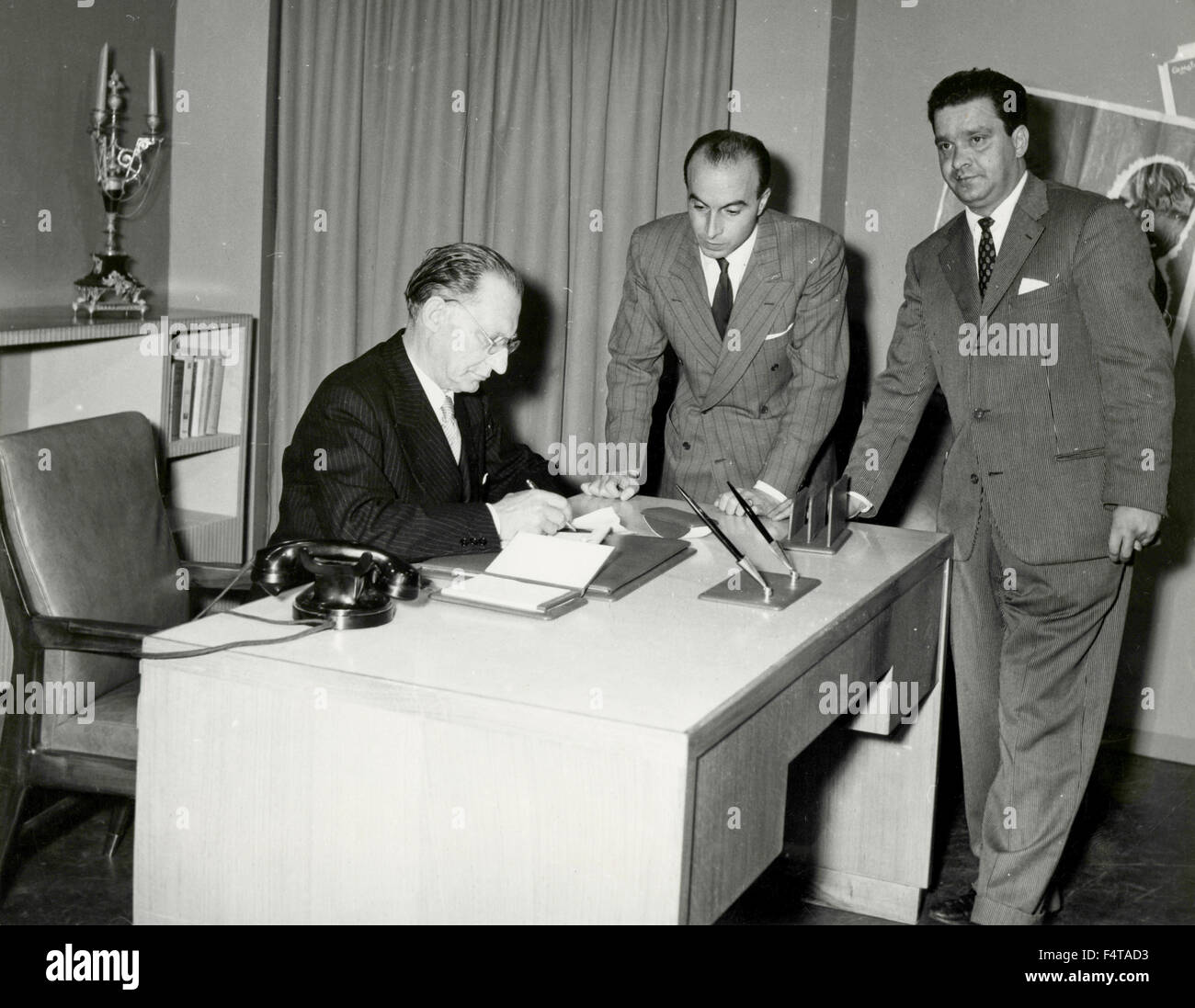 The Italian Prime Minister Alcide De Gasperi signing documents, Italy ...