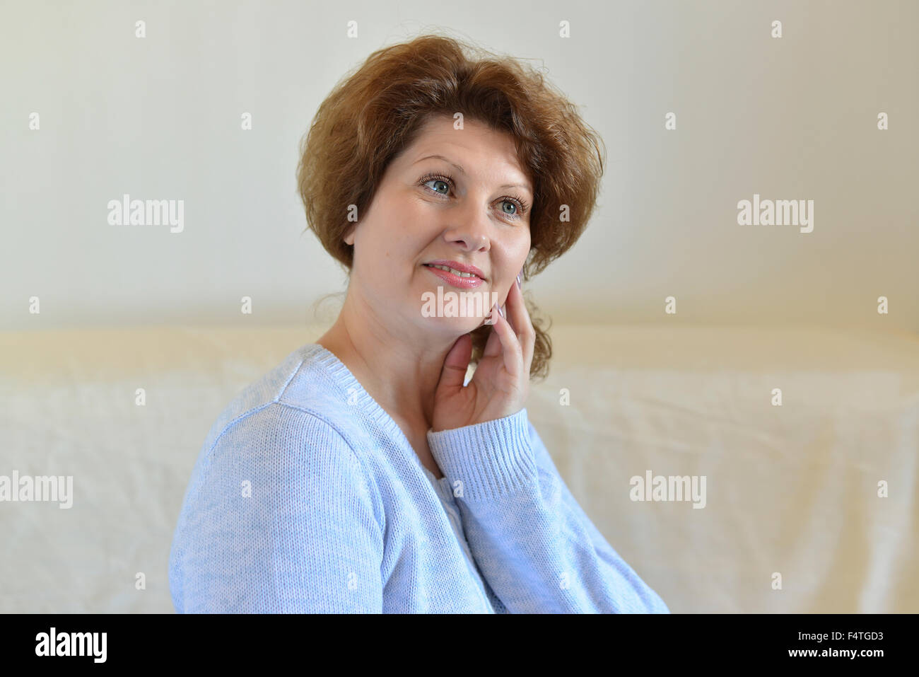 Woman dreaming sitting on a couch Stock Photo Alamy