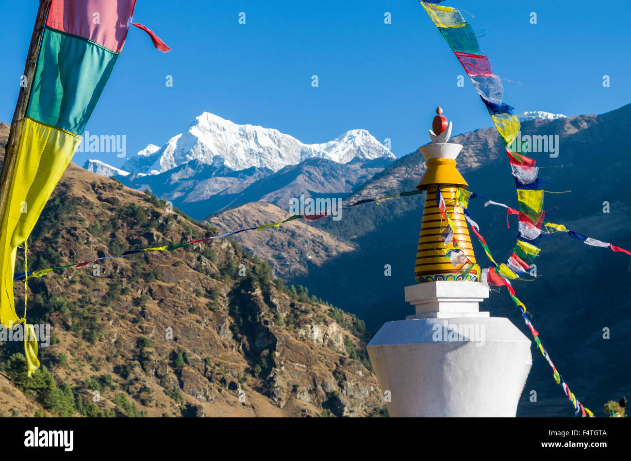 Shorang Himal mountain range behind a white stupa Stock Photo