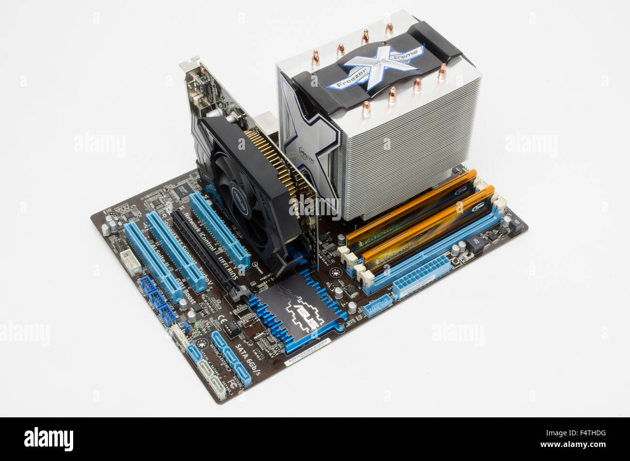 ASUS motherboard with Arctic Cooler Freezer Xtreme CPU cooler, Team Vulcan DDR3 memory sticks, and ASUS graphics card in situ. Stock Photo