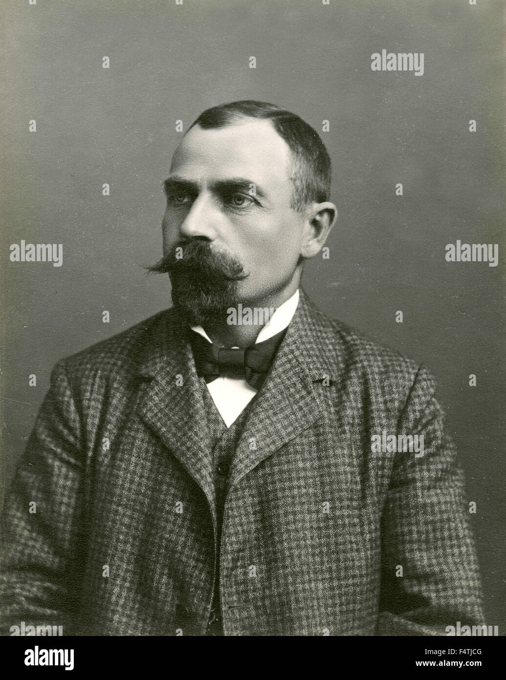 Portrait of a man in a suit and bow tie Stock Photo - Alamy