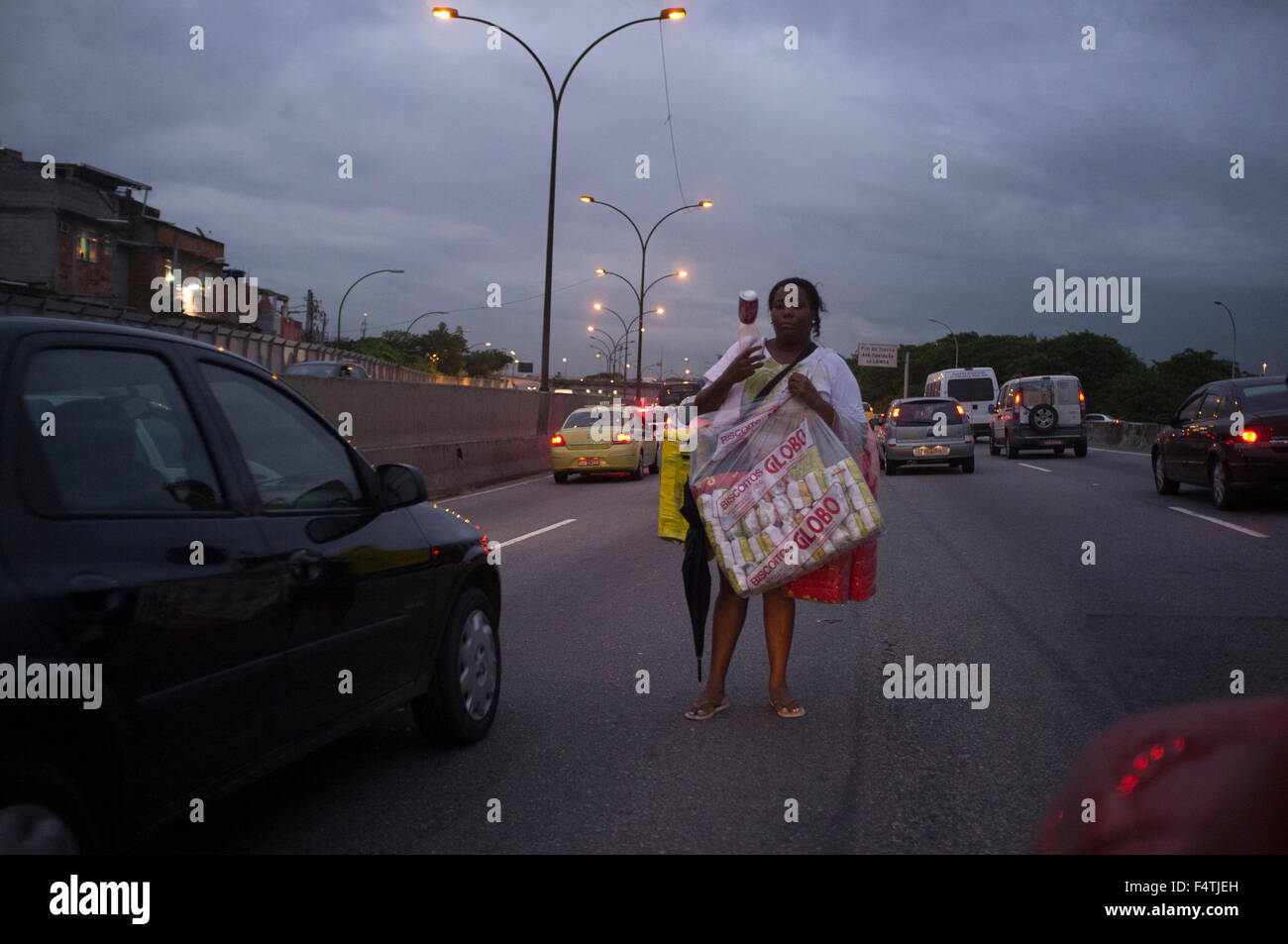 Street vendor work at Linha Vermelha expressway traffic jam in Rio de Janeiro. Stock Photo