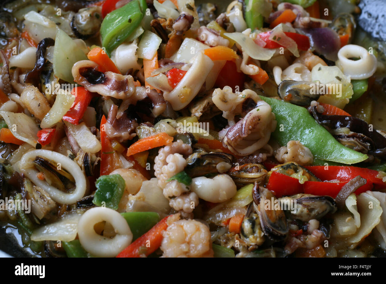 Seafood with vegetables stewed on frying pan Stock Photo