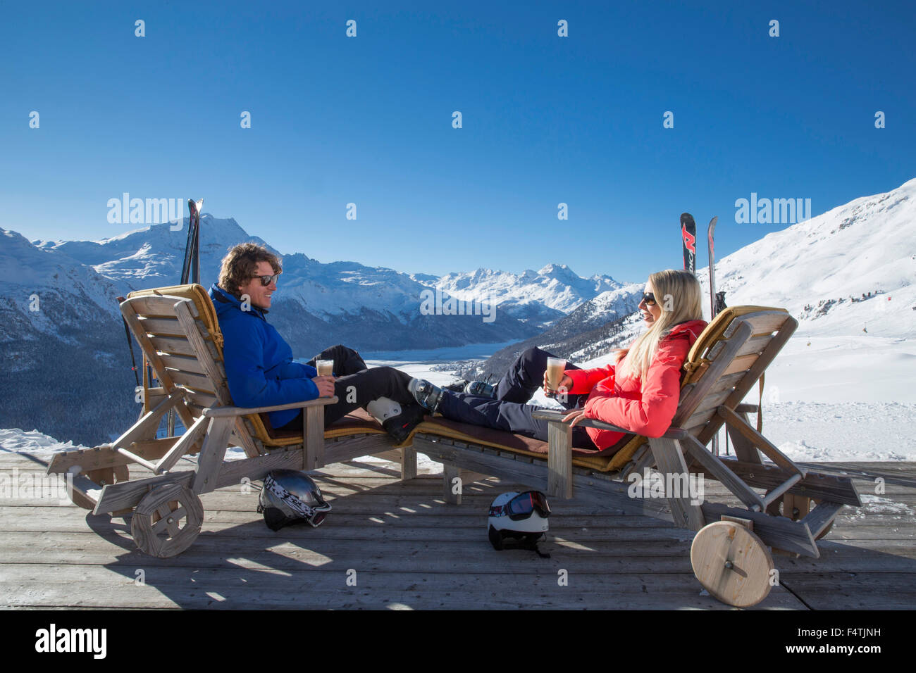 Couple in deck chairs in mountain restaurant Trutz, Engadine, Stock Photo