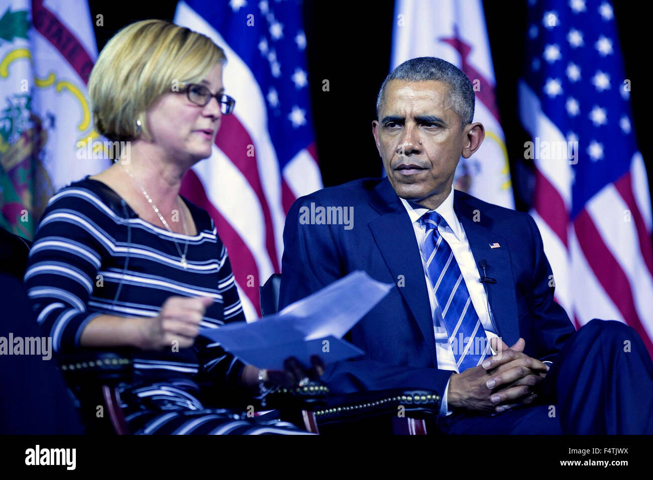 Charleston, West Virginia, USA. 22nd Oct, 2015. U.S. President Barack Obama listens to panelist Cary Dixon speak about being a mother of a son now in recovery and receiving drug treatment in prison during a community forum on the prescription drug abuse and heroin epidemic at the East End Family Resource Center October 21, 2015 in Charleston, West Virginia. Stock Photo