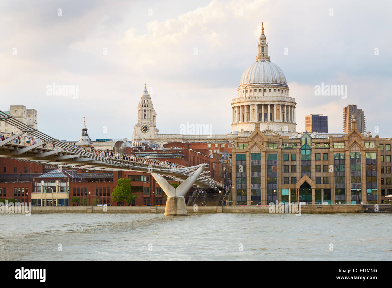 St Paul Cathedral and Millennium bridge with people in London afternoon, natural colors Stock Photo