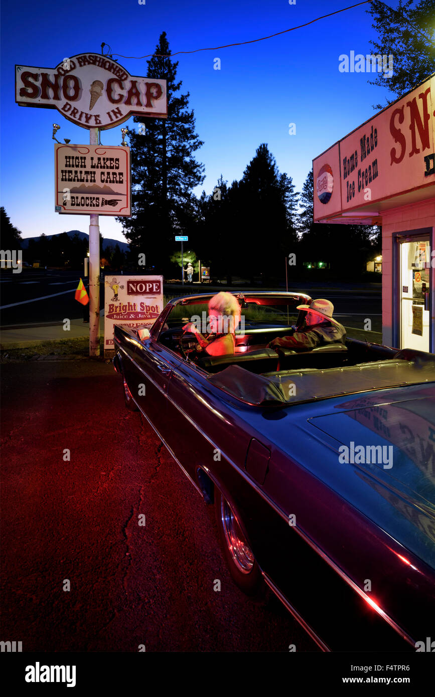USA, Oregon, Sisters, Snowcap, Drive in and Ford Galaxy at dusk Stock Photo
