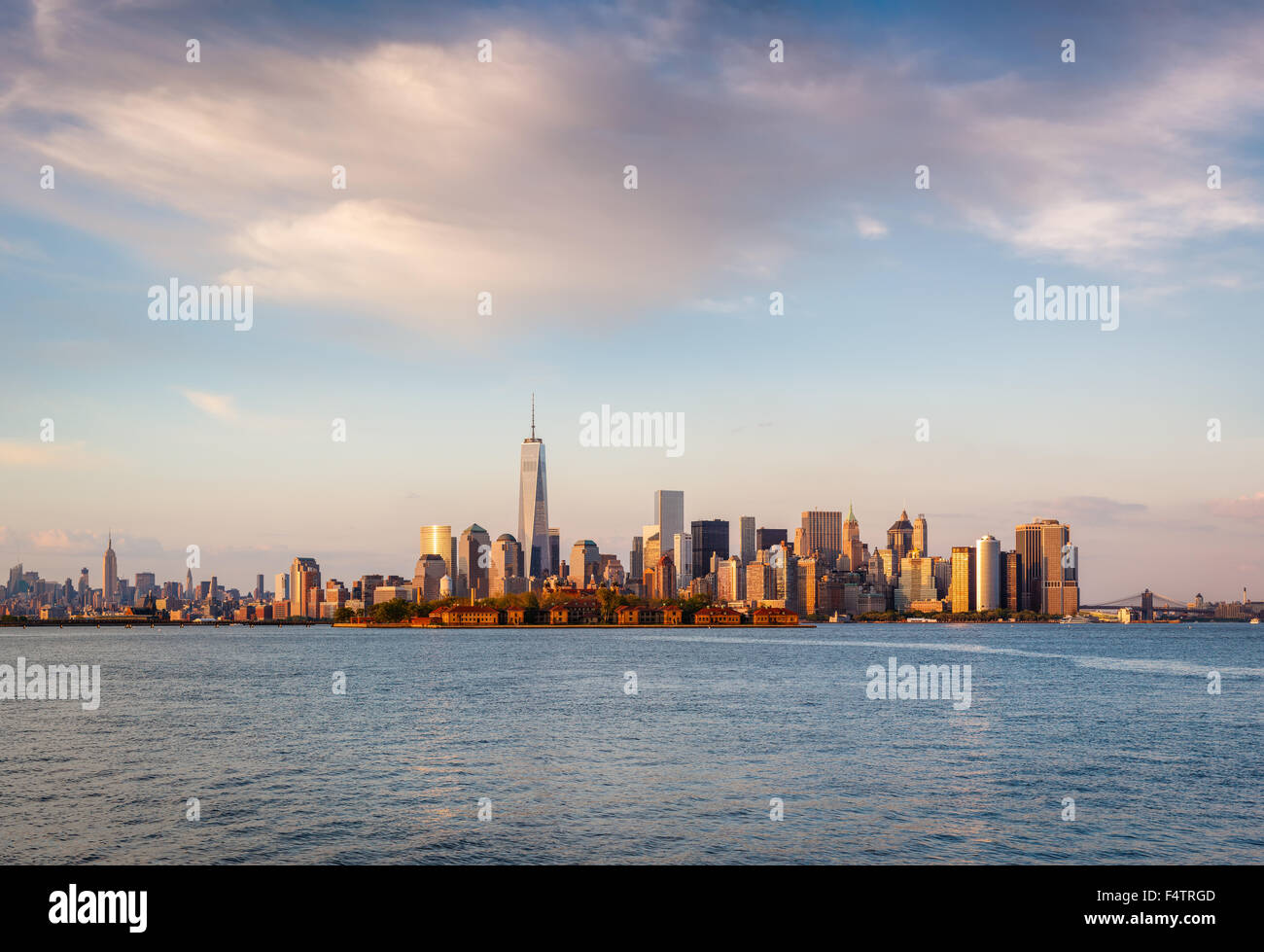 New York skyscrapers and Lower Manhattan's Financial District in sunset light with Battery Park and Ellis Island. New York City Stock Photo