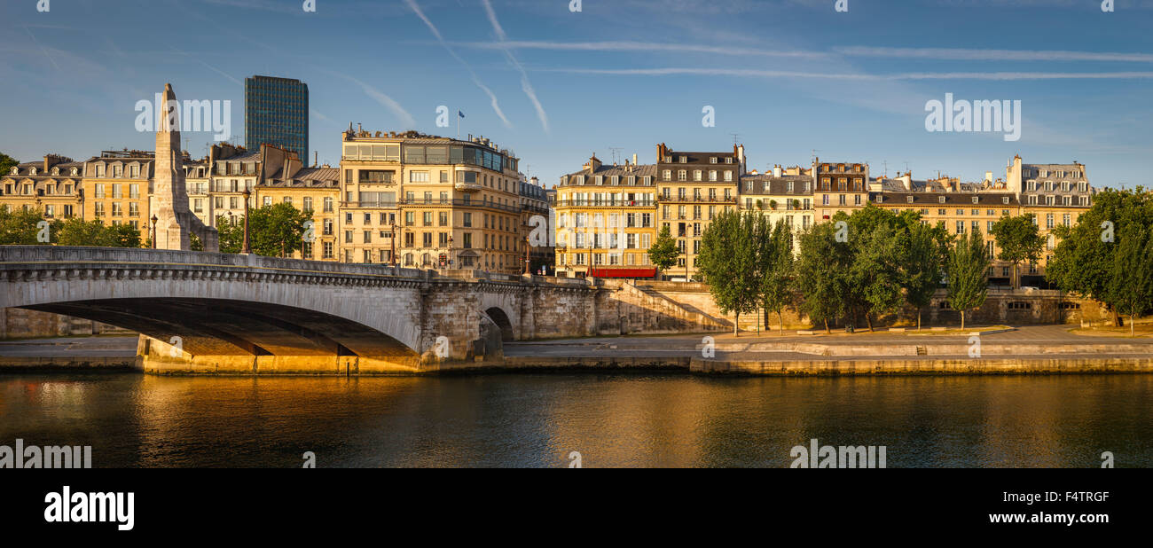 Seine River left bank with the Tournelle bridge (pont de la Tournelle) and its statue of Sainte Genevieve. Paris, France Stock Photo