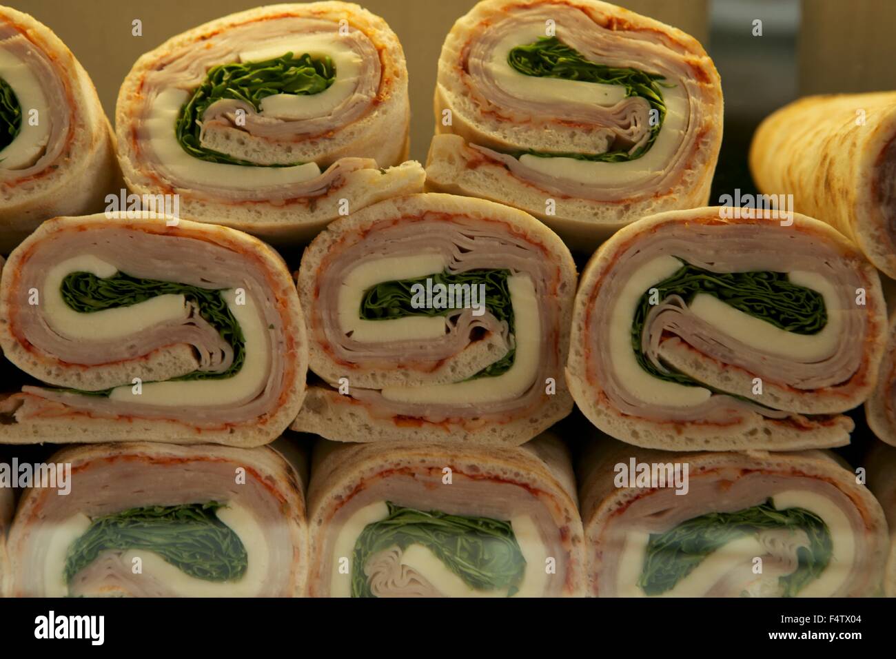 food snacks sandwiches in a display window of a cafe in Italy Venice sandwich of cheese Italian prosciutto and lettuce Stock Photo