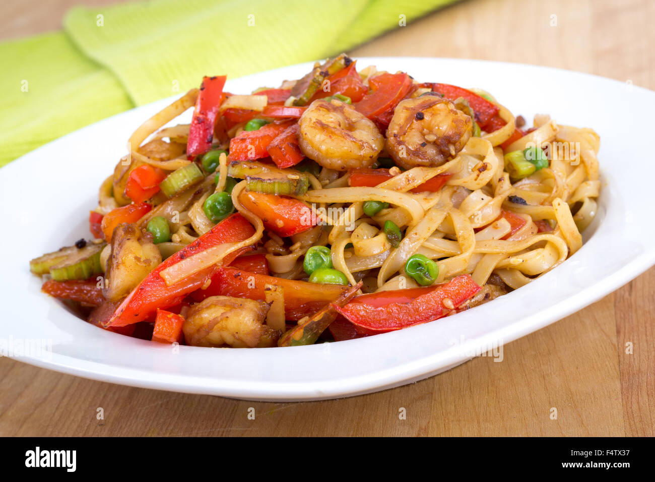 Shrimp stir fried with pasta and red bell pepper in a bowl Stock Photo