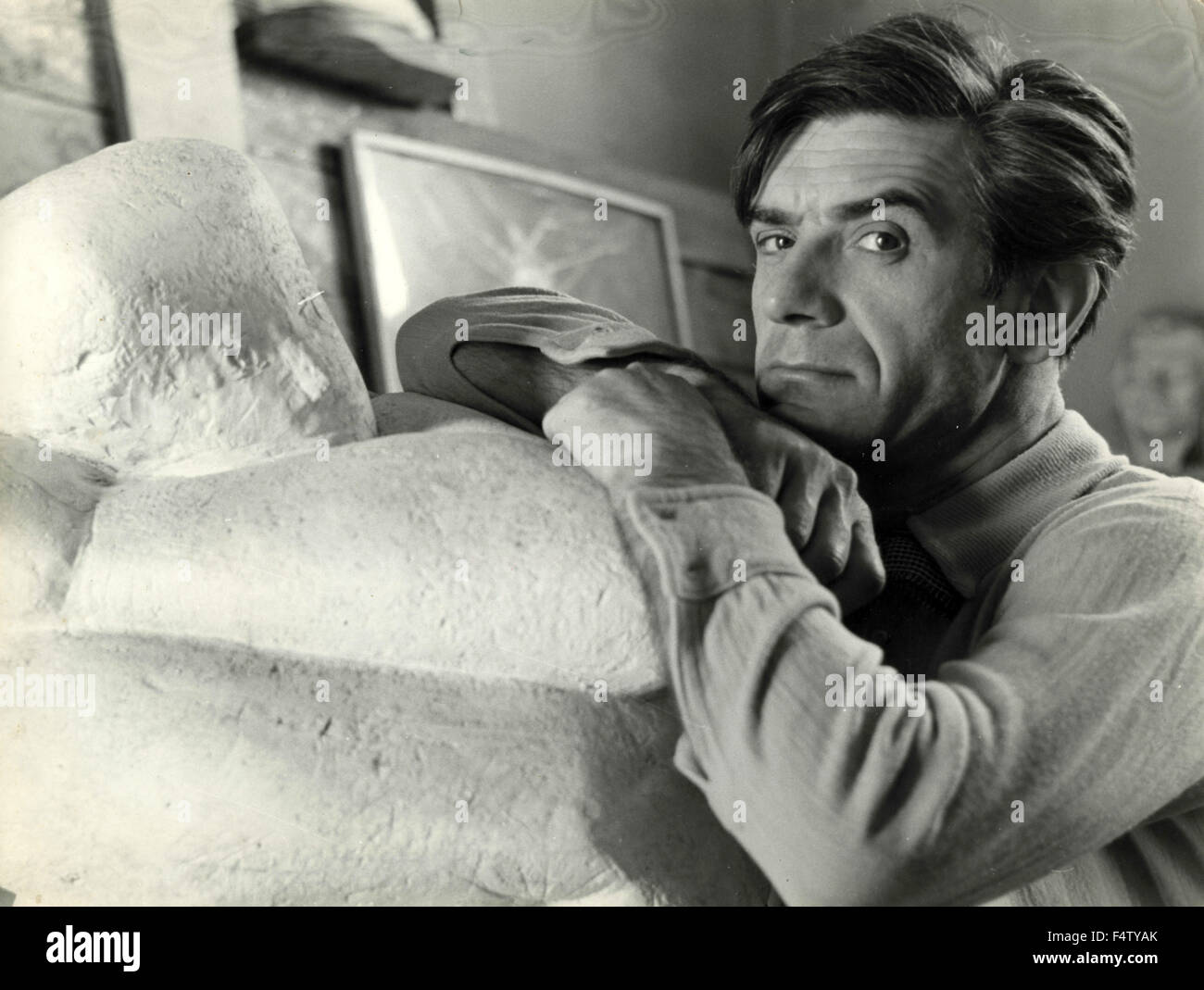 Hungarian sculptor and actor Imre (Amerigo) Tot next to one of his ...