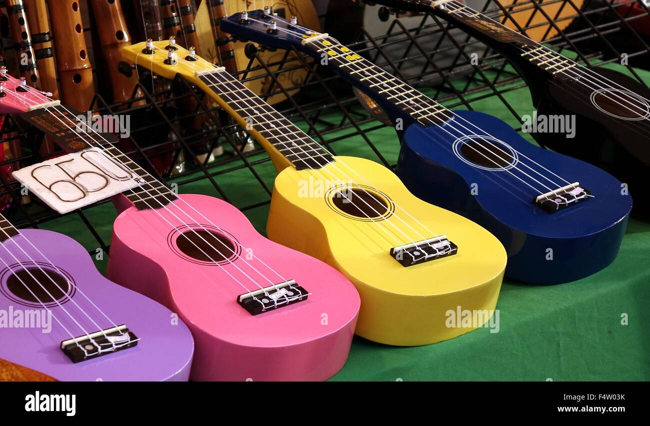 Colorful ukuleles on sale at an outdoor stall Stock Photo