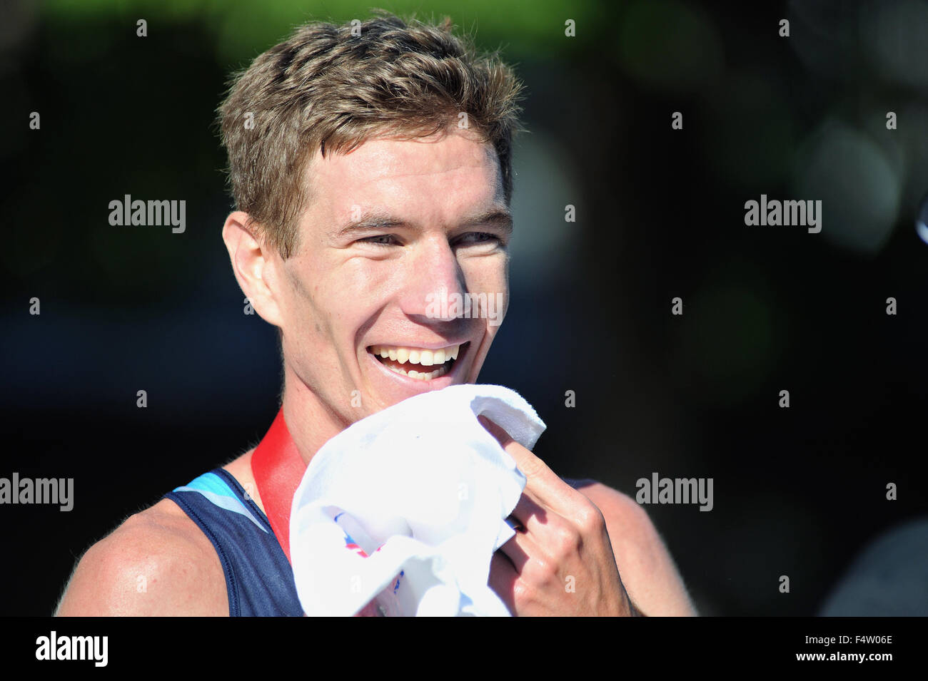 After crossing the finish line at the 2015 Chicago Marathon, Luke Puskedra of the United States appears refreshed and happy. Stock Photo