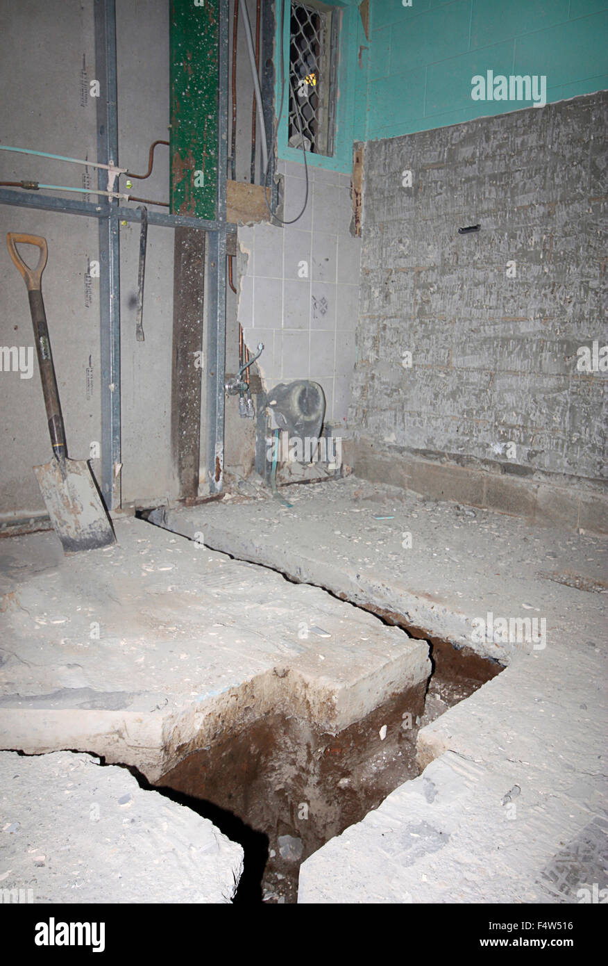 renovating an old bathroom and cutting through the concrete for the