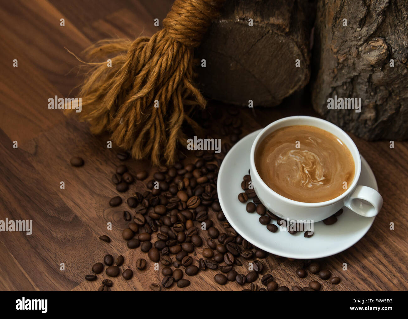 Cup of coffee with beans in earthy setting Stock Photo - Alamy