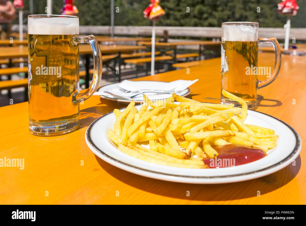 French fries with a beer on the table Stock Photo Alamy