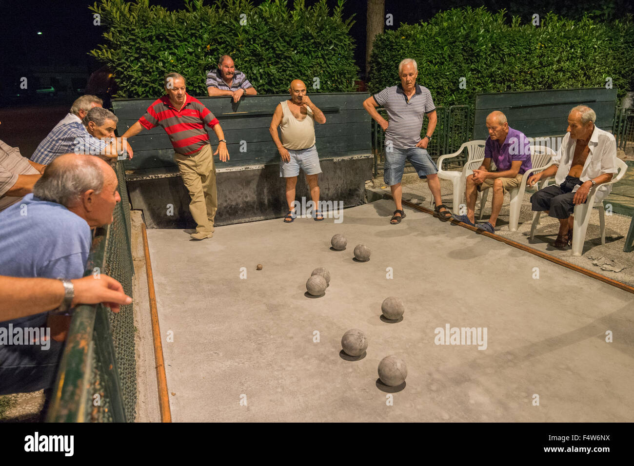 Local men being played bocce ball on outdoor court in Colle di Val d'Elsa, Tuscany, Italy. Stock Photo